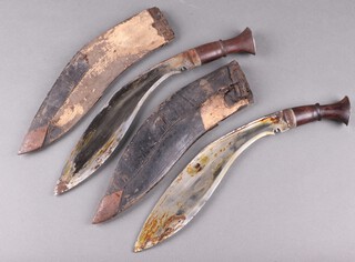 Two 1930's Kukri with wooden handles and leather scabbards