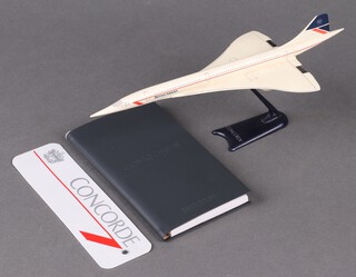 A plastic model of Concorde 24cm, a Concorde luggage label and a ditto notebook 