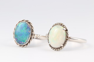 A silver dress ring set an "opal", size L and 1 other size Q 1/2 
