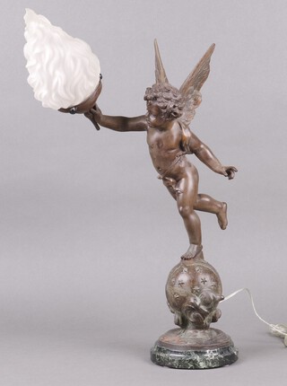 After Emile Bruchon, a spelter lamp in the form of a cherub with wings outstretched and with glass torch shade, the base marked L'amour Vagabond 47cm   