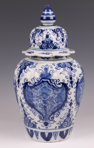 An 18th Century Delft blue and white urn and cover 37cm 