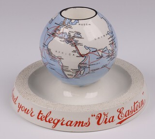Mintons, an advertising match striker in the form of a globe, the base marked "Send Your Telegrams Via Eastern", the base marked A W Savill & Co, 11cm 