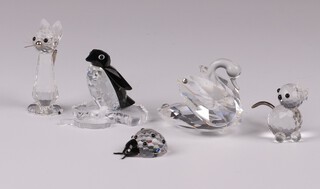 Four Swarovski Crystal figures - cat 5cm, penguin 4cm, cat 3cm all boxed and ladybird 3cm together with a crystal glass swan 4cm 