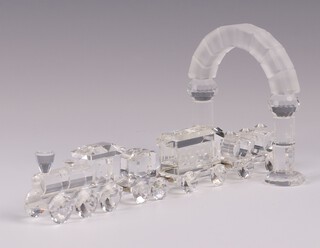 A Swarovski Crystal 4 section model train comprising locomotive, tender, carriage and 3 barrelled truck, together with an arch 9cm 