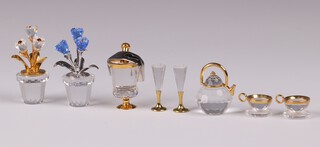 A collection of Swarovski Crystal ornaments in the form of pot plants 4cm, a tea set with kettle, 2 cups and saucers, a wine cooler and champagne flutes, all boxed