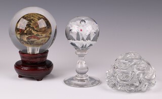 A Baccarat glass paperweight 6cm, a shaped glass paperweight 4cm and a Chinese interior painted glass paperweight on a wooden stand 9cm 