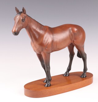 A Beswick figure of a racehorse - Mill Reef, raised on an oval oak base, 24cm 
