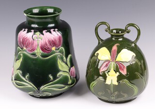 Julius B Dressler, an Austrian Art Nouveau green glazed pottery twin handled vase decorated lilies 22cm, the base marked J D Austria 640 together with a flared vase of waisted form 26cm (chips to rim) 