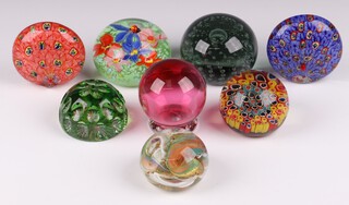 Two peacock glass paperweights and 6 other paperweights 