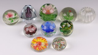 A Rosenthal Andy Warhol paperweight, a Westwood paperweight with green swirl decoration no. 189, a faceted purple glass candle holder and 7 other paperweights 