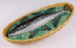 A George Jones Majolica mackerel oval fish tureen and cover, the base in the form of a basket, the lid in the form of a mackerel on a bed of leaves, circa 1871, 8cm h x  38.5cm l x 19cm w, with impressed registration lozenge 