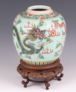 A circa 1900 Chinese green glazed ginger jar decorated a running dragon 20cm with hardwood stand (stand a/f) 