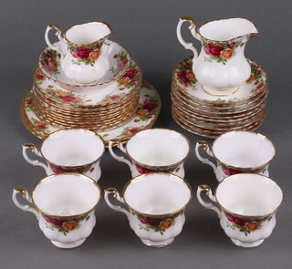 A Royal Albert Old Country Roses pattern 30 piece tea service comprising milk jug, cream jug, 2 side plates, 10 tea plates (7 seconds), bowl (second), 9 saucers (3 seconds), 6 cups (2 cracked, 2 seconds) and 2 Royal Albert Silver Maple pattern saucers 