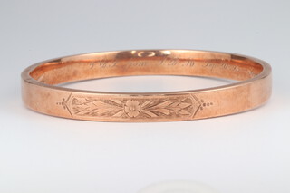 A 9ct rose gold engraved bangle, the interior engraved VBS from SBM September 20th 1915-September 20th 1925, 15.8 grams 