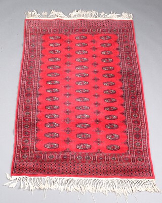 A red and black ground Bokhara rug with 42 octagons to the centre, 154cm x 95cm