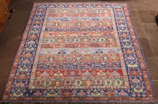 A blue and brown ground Persian carpet, the rectangular central medallion formed of 13 rectangular panels within a multi row border 276cm x 237cm 