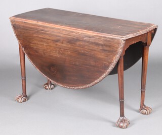 An Irish 18th Century oval mahogany drop flap gateleg dining table, the edge with carved floral and trellis decoration, raised on tapering supports with ring turned carved studded collars, web and talon ball and claw feet 74cm h x 118cm w x 45cm w when closed x 144cm when open 