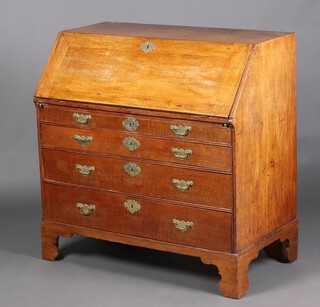 An 18th Century oak bureau, the fall front revealing a stepped fitted interior with drawers and well above 4 drawers with original brass plate drop handles, raised on bracket feet 108cm h x 106cm w x 59cm d 