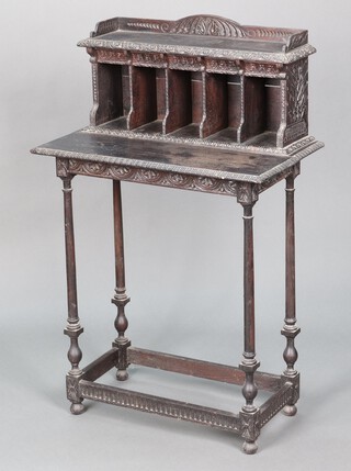 A Victorian rectangular carved oak side table, the raised back with 3/4 gallery fitted 5 pigeon holes, raised on turned supports 109cm h x 69cm w x 38cm d 