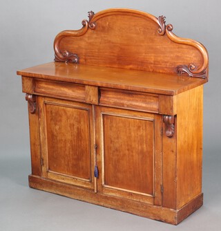 A Victorian bleached mahogany chiffonier with carved raised back fitted 2 short drawers, the interior fitted a shelf and cellarette drawer enclosed by panelled doors, raised on a platform base 125cm h x 121cm w x 43cm d 