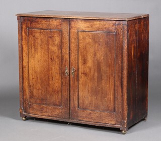 A 19th Century oak press cabinet, the interior fitted 4 trays enclosed by panelled doors with columns to the sides, 92cm h x 103cm w x 50cm d 