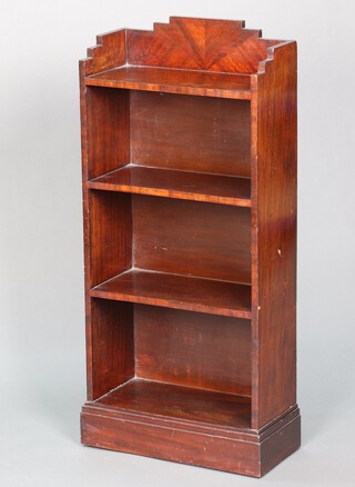 A 1930's Art Deco mahogany 4 tier bookcase with raised shaped back, raised on a platform base 100cm h x 48cm w x 22cm d 