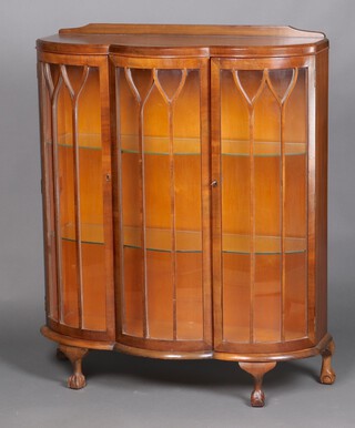 A 1930's Art Deco walnut display cabinet with raised back fitted 2 glass shelves enclosed by astragal glazed panelled doors, raised on cabriole supports 124cm h x 100cm w x 38cm d 