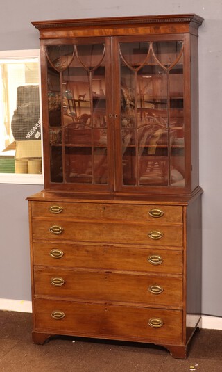 A Georgian mahogany secretaire bookcase, the upper section with moulded and dentil cornice fitted adjustable shelves enclosed by an astragal glazed panelled door with well fitted secretaire drawer having pigeon holes and drawers, above 3 long drawers, raised on bracket feet 210cm h x 104cm w x 55cm d  