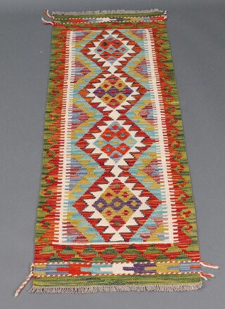 A green, white and tan ground Chobi Kilim runner with 4 diamonds to the centre 148cm x 53cm 