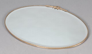 A 1920's oval bevelled plate wall mirror contained in a metal frame surmounted by a ribbon and garland 50cm h x 74cm w