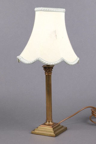 A gilt metal reeded Corinthian column table lamp raised on a square stepped base 25cm h