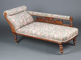 An Edwardian carved walnut chaise longue upholstered in tapestry material raised on turned supports 139cm h x 172cm w x 60cm d