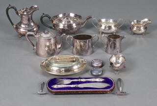 A four piece silver plated tea service comprising tea pot, hot water jug, cream jug and sugar bowl, a Brittania metal three piece service, a pair of cased silver plated fish servers and other plated items