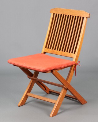 A hardwood slatted folding garden chair