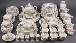 A Mason's 85 piece green Fruit basket pattern dinner/tea service comprising oval meat plate, two rectangular dishes, 9 dinner plates (1 af) and a similar Johnson Bros dinner plate, 6 soup bowls, 9 side plates, 6 tea plates, 6 pudding bowls, 6 Johnson Bros pudding bowls, two twin handled bread and butter plates, sauce ladle and stand, two cream jugs, dish, small circular dish, tea pot, sugar bowl, breakfast cup and saucer, 11 cups and saucers, pepper and salt, three egg cups, a twin handled plate, a circular bowl, 2 jugs and a vase together with a Masons red plate decorated Sutton Palace (cracked), a Mason's red fruit basket plate, ditto saucer and ginger jar together with two Mason's 1981 Royal Wedding mugs