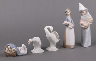 A Lladro figure of a standing girl with chicken the base marked A99 19cm, ditto girl with pig B-26 17cm, 2 Lladro figures of geese marked 13 and 51 and duck with ducklings 4895 4cm