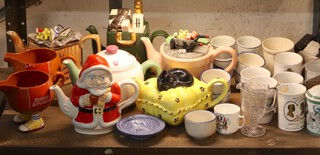 Two Brown and Polson sauce boats, a novelty pottery Santa Claus teapot and 5 novelty pottery teapots and a collection of commemorative mugs 
