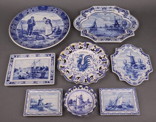 Five Delft blue and white wall plaques decorated canal scenes, a Delft charger and 2 Delft dishes