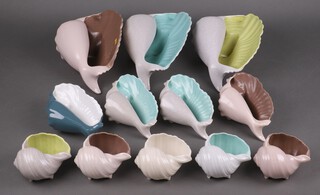 Three Poole pottery shell shaped vases 28cm high together with nine others