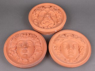 Three circular terracotta wall masks, portraits of classical ladies 26diam 