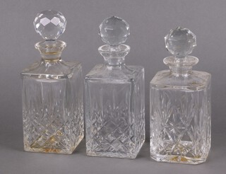 Three cut glass spirit decanters and stoppers
