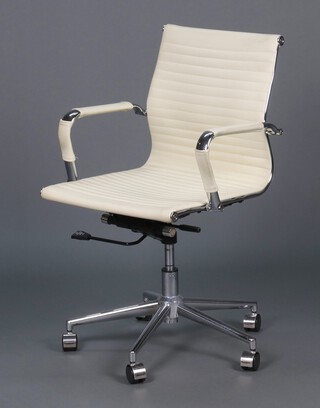 A revolving office chair upholstered in white material
