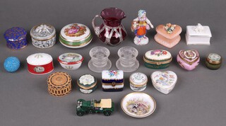 A collection of miniature trinket boxes together with a ruby glass jug