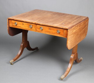 A Regency bleached mahogany sofa table inlaid satinwood stringing, fitted 2 frieze drawers, raised on reeded standard end supports with gilt metal caps and casters 69cm h x 87cm w x 69cm d 