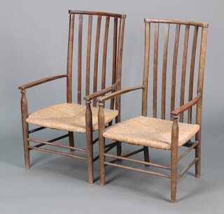 A pair of Edwardian beech stick and rail back open arm chairs with woven cane seats (heavily wormed) 85cm h x  48cm w x 43cm d