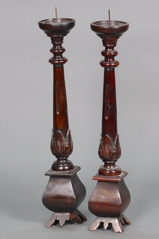A pair of turned mahogany 17th Century style pricket candlesticks 86cm 