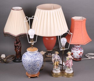 A table lamp in the form of a Chinese style blue and white urn and four other table lamps