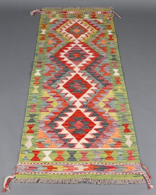 A white, green and terracotta ground Chobi Kilim runner with diamond design to the centre 196cm x 72cm 