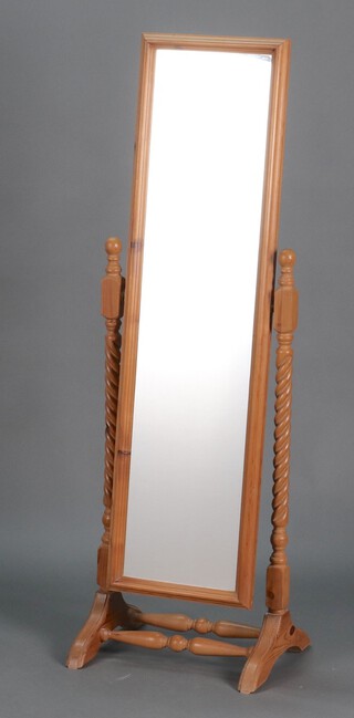 A rectangular plate cheval mirror contained in oak frame with spiral turned columns to each side 145h x 46w x 38d