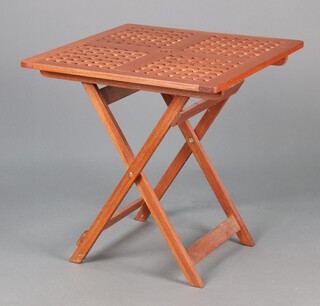 A square pierced hardwood folding garden table 72h x 70w x 71d together with a smaller matching table 49h x 50w x 50d